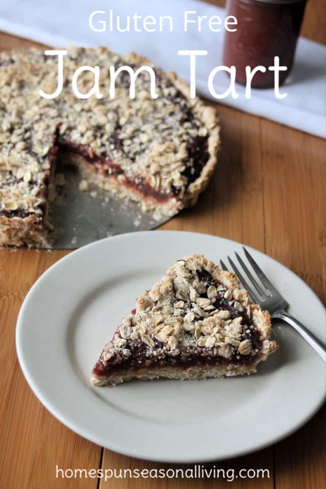 A slice of gluten-free jam tart on a plate with a fork.