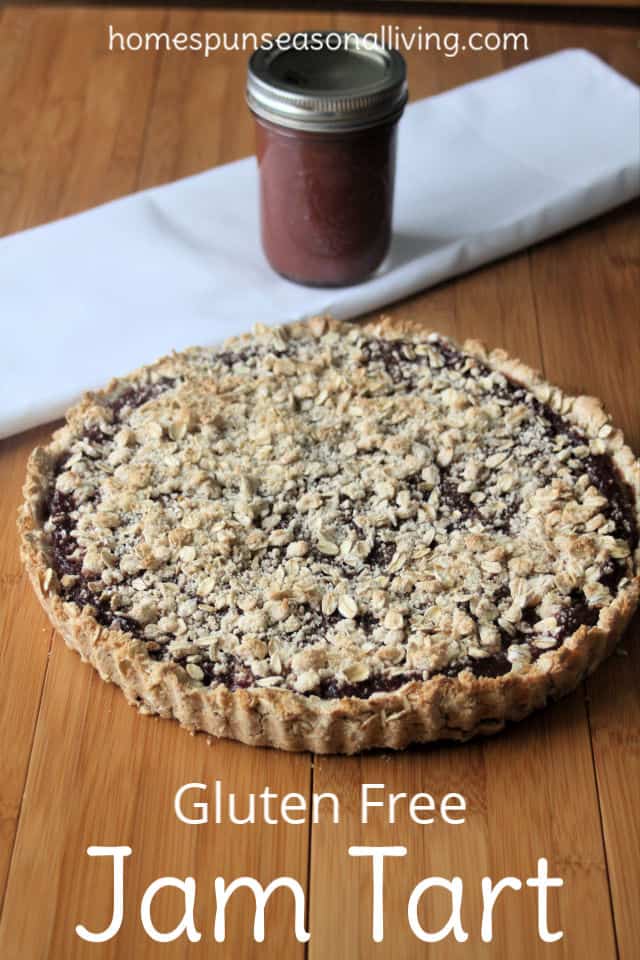 Gluten-Free Jam Tart on a table with napkin and jar of jam.