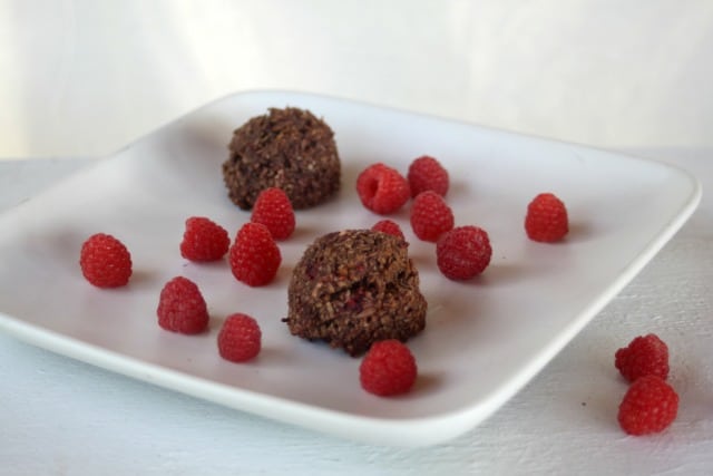 Chocolate Raspberry Coconut Macaroons on a plate with fresh raspberries
