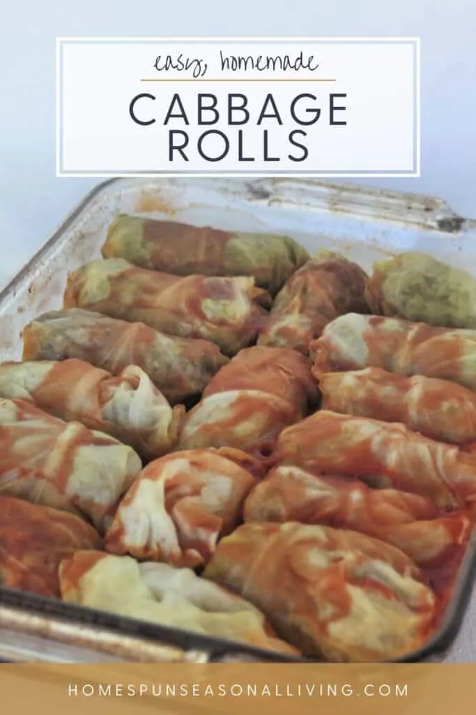 A glass baking tray full of cooked cabbage rolls covered in tomato juice with text overlay reading: easy, homemade cabbage rolls.