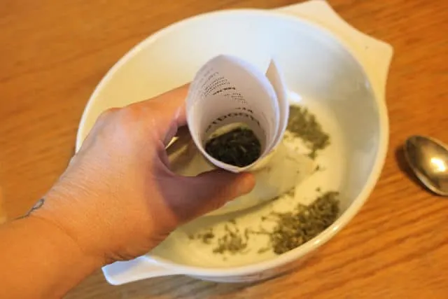 Dream pillow being filled via a funnel with herbs.