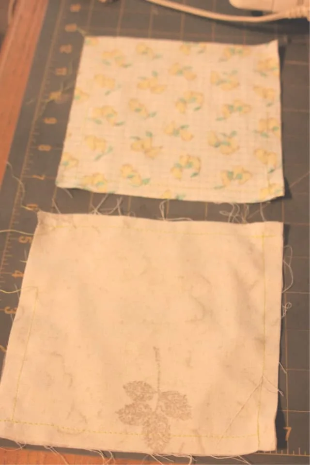 Two pillow case squares sewn together on a table.