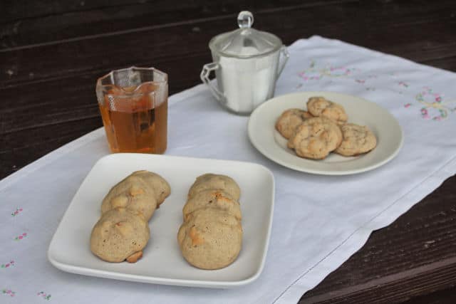 Dried apple cookies on plates with pitchers of maple syrup and sugar.