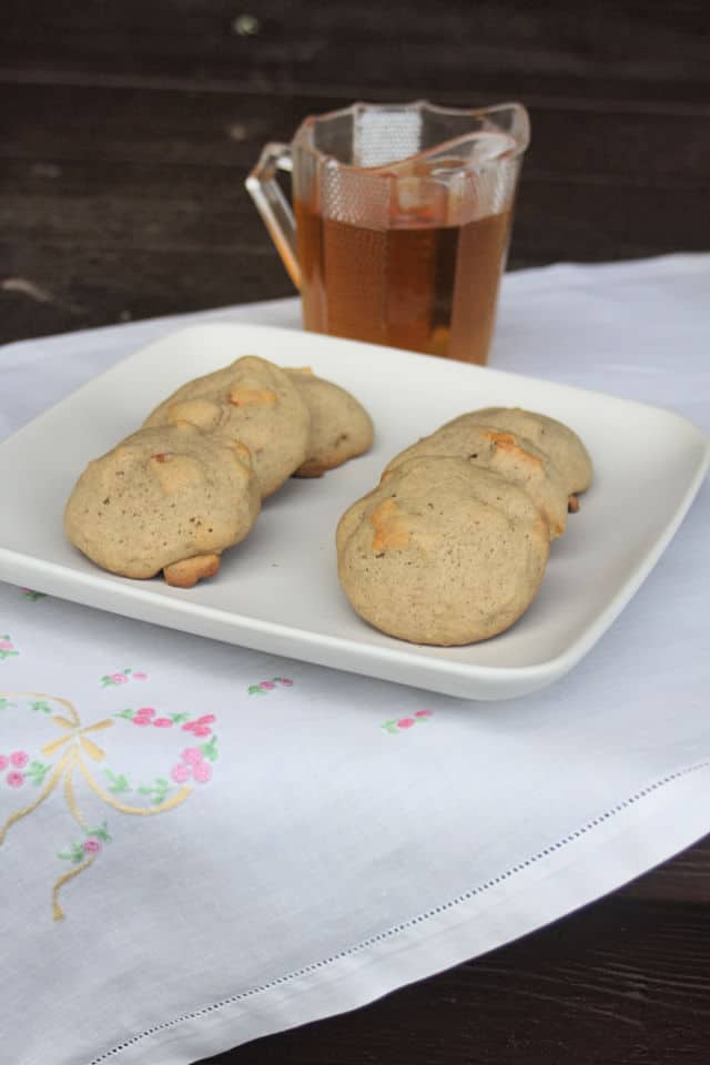 Dried apple cookies on a plate with maple syrup.