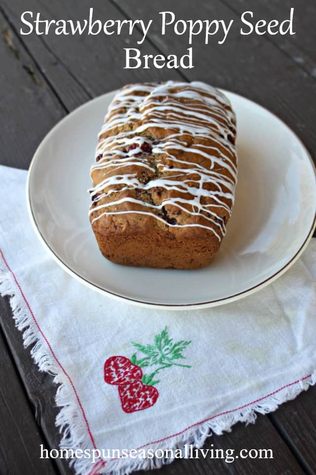 Glazed Strawberry Poppy Seed Bread Loaf on a platter with napkin.