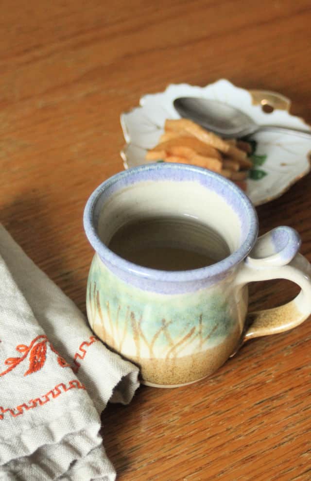 Cup of dried apple tea with napkin.