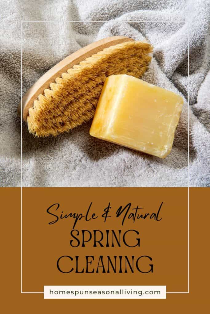 A wooden scrub brush and bar of soap sit on a towel. Text overlay reads: simle & natural spring cleaning. 