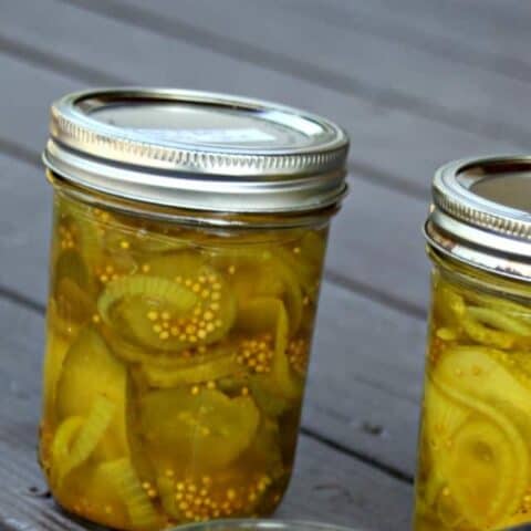 Jars of bread and butter pickles on a table