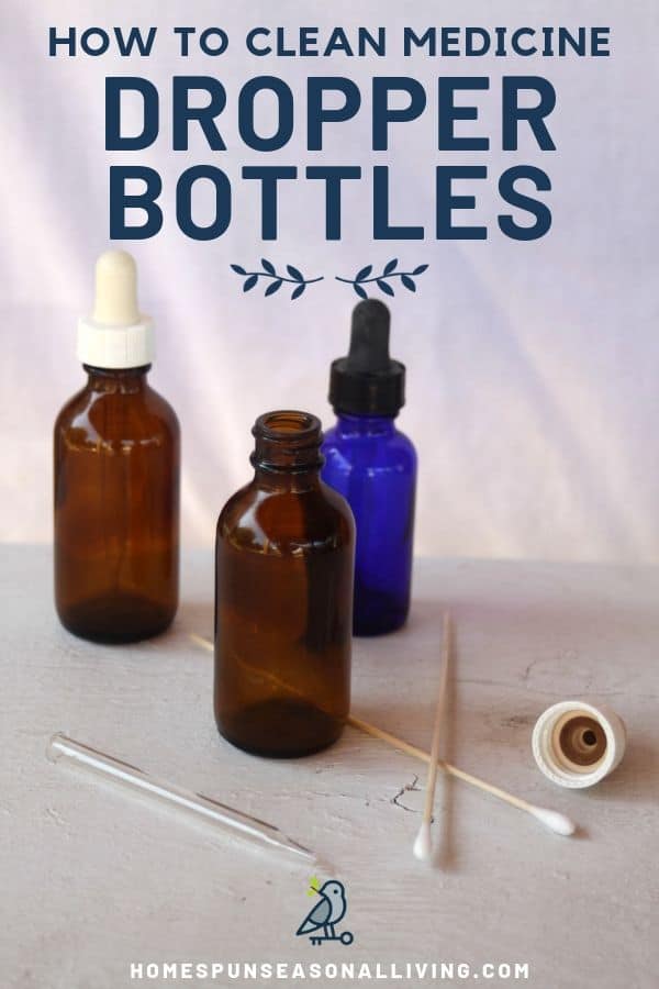 Amber and blue glass medicine dropper bottles sitting on a table with cotton swabs for cleaning.