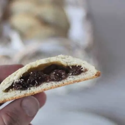 A rum raisin filled cookie cut in half to expose the filling.