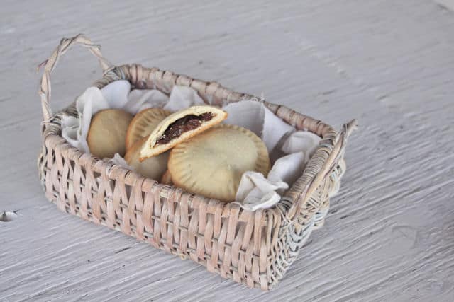 Rum raisin filled cookies stacked in a basket.