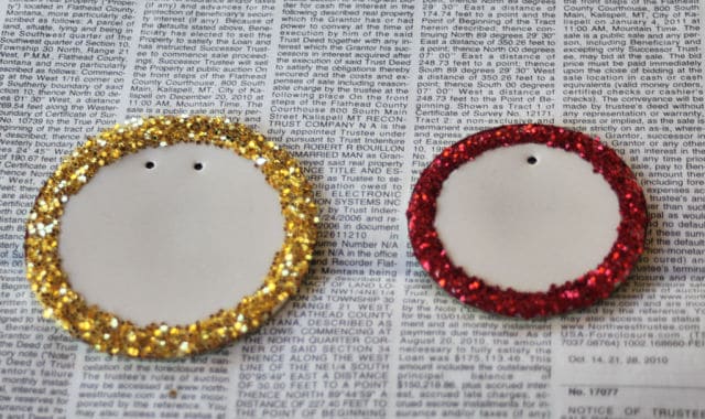 Canning lids decorated with glitter to be used for gift tags.