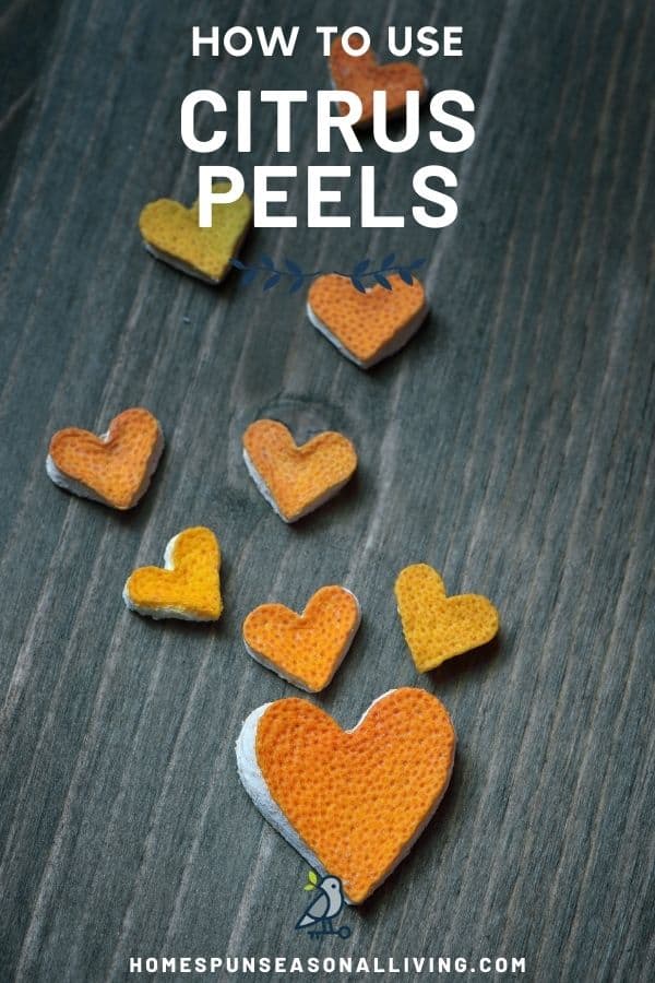 Lemon and orange peels cut into heart shapes scattered on a table top with text overlay reading: how to use citrus peels.