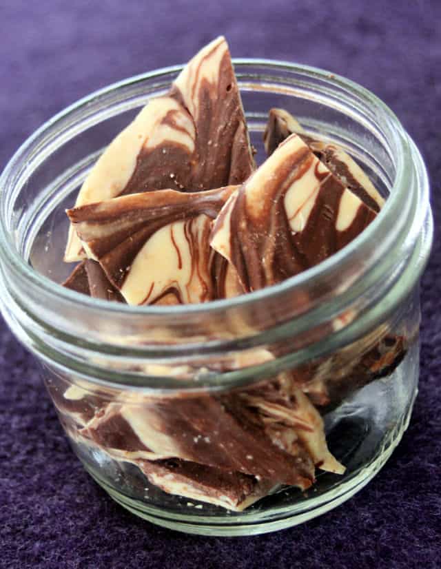Dark chocolate and white chocolate swirled chocolate bark in a jar.