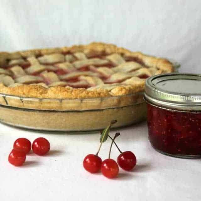 Sour cherry pie with jam and raw cherries.