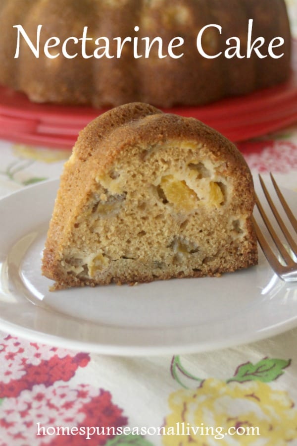 A slice of nectarine cake on a place with a fork.