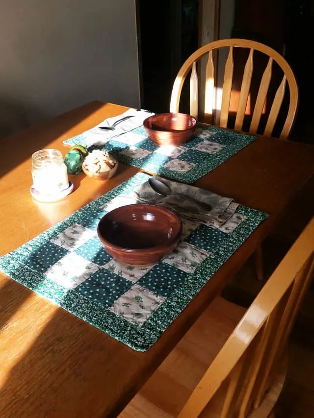 Table set for two with bowls on place mats.