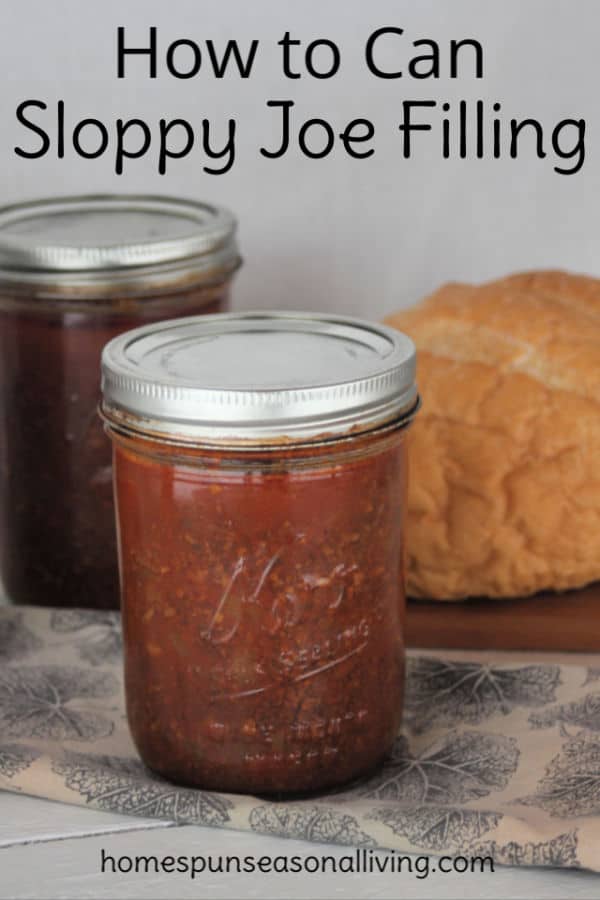 Jars of canned sloppy joe filling in front of a loaf of bread.