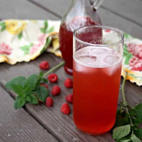 Drink up the summer season with a fruity and herb filled glass full of refreshment for hot days in the form of a raspberry lemon balm shrub.