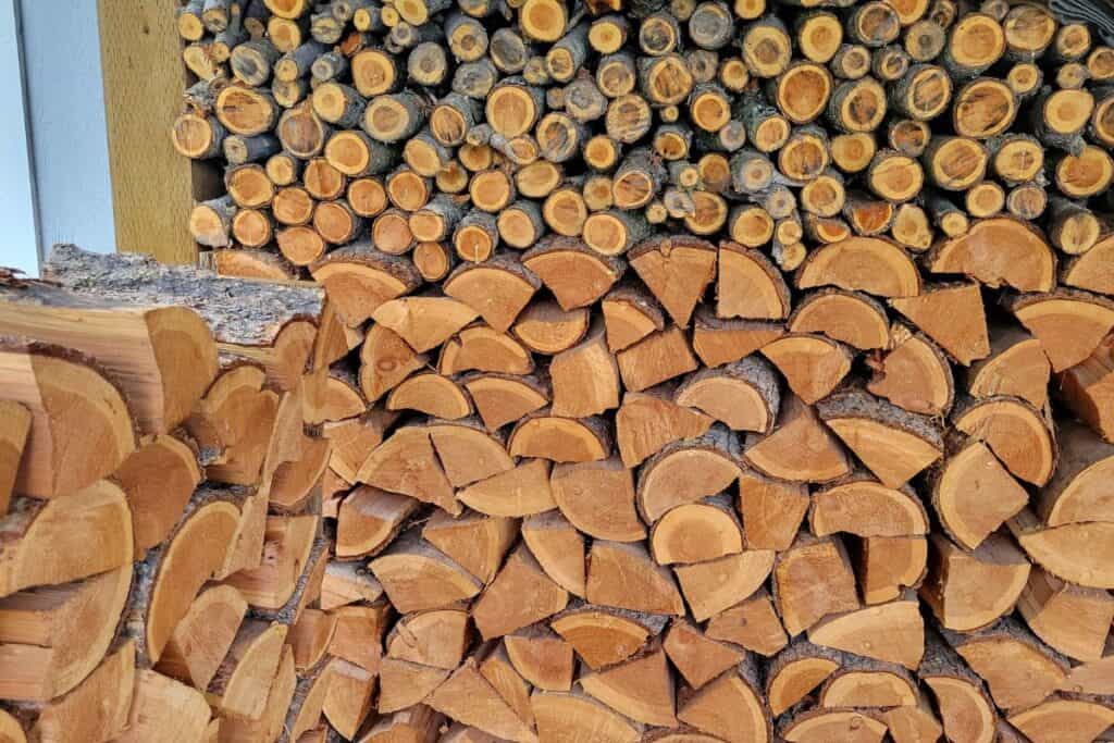 Small branches and split logs sit in a rack to use for winter heating. 