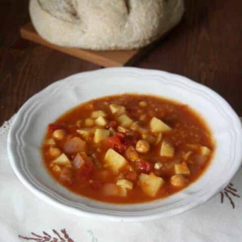 A bowl of sweet potato stew sitting on a napkin.