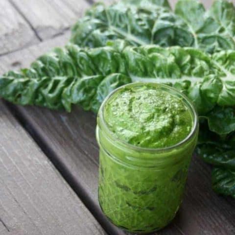 Pesto in a jar with leaves.