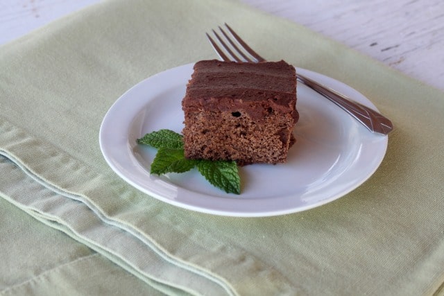 A frosted fresh mint brownie on a plate.