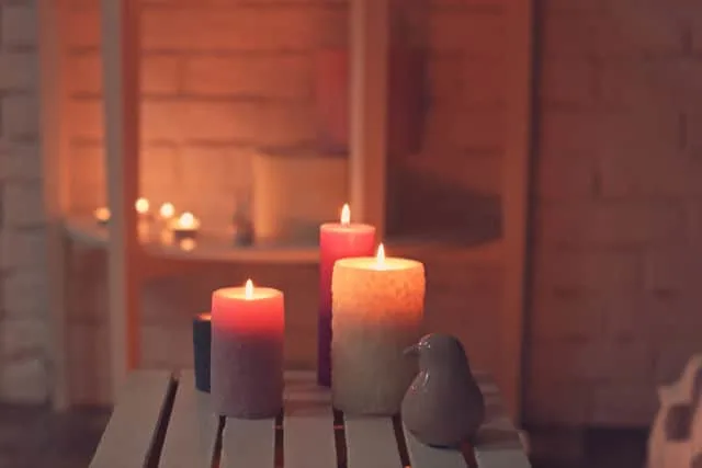 Burning candles on a wooden crate.