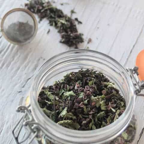 A jar of chocolate mint tea blend with tea ball.