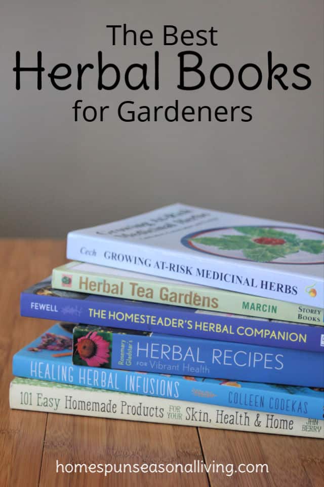 Stack of herbal books on a table.