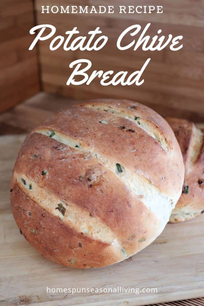 2 loaves of bread showing bits of green chives and potato skins on the crust sit on a board. Text overlay reads: Homemade Recipe: Potato Chive Bread.