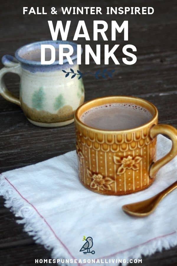 Mugs of warm drinks sitting with a napkin and spoon.