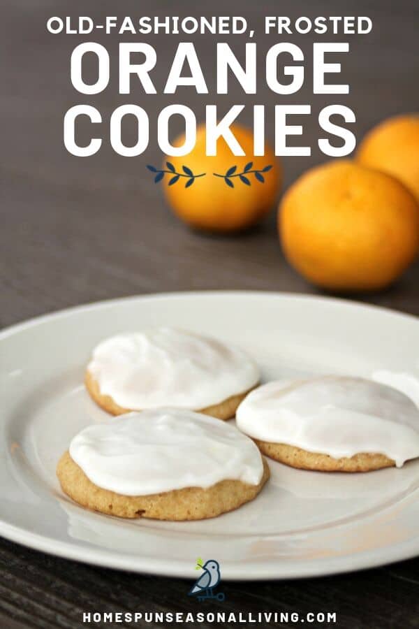 3 frosted orange cookies on a white plate