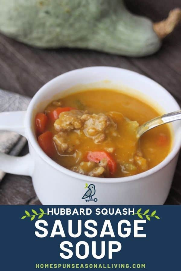  Hubbard Squash Sausage Soup in a white cup with a spoon sitting in front of a hubbard squash.