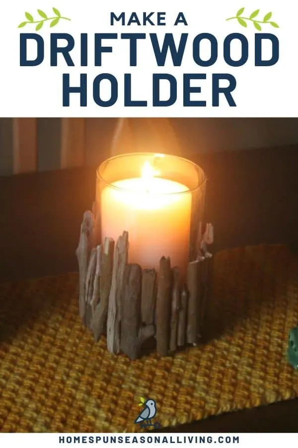 A darkened room with lit candle in a driftwood candle holder on a placemat. 