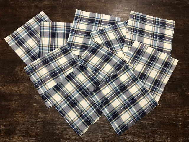 Squares cut from flannel shirts sitting on a table.