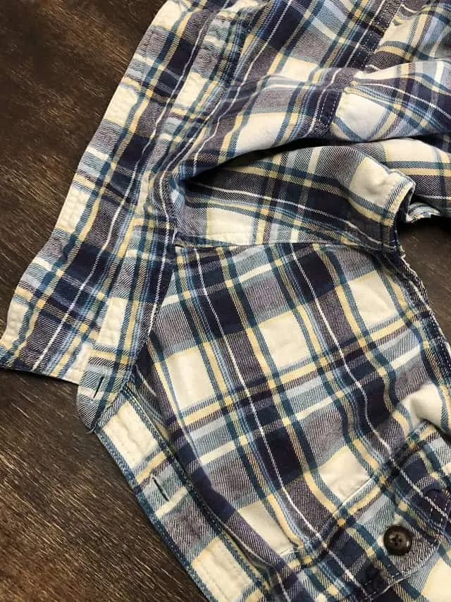 A flannel shirt piece being taken apart.