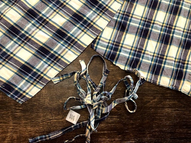 Pieces of a flannel shirt having the hems removed.