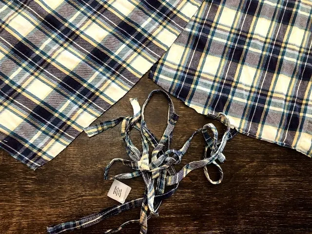 Pieces of a flannel shirt having the hems removed.