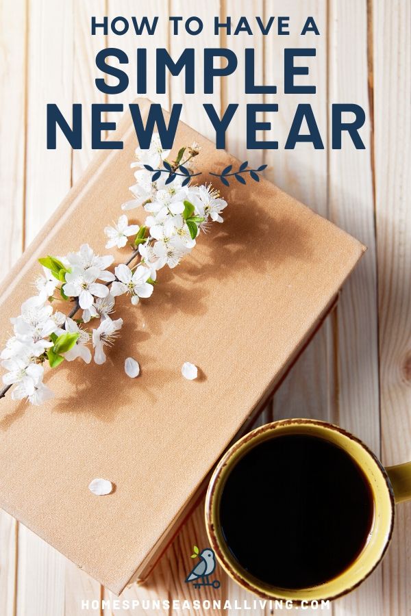 A book on a table with flowers and cup of coffee.