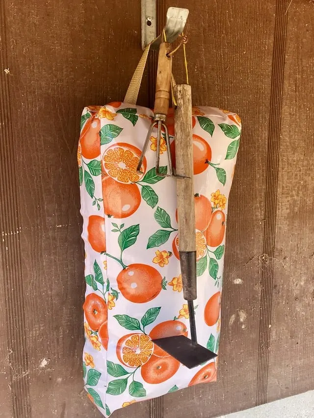 Hanging Garden Kneel Pad with oranges and garden tools