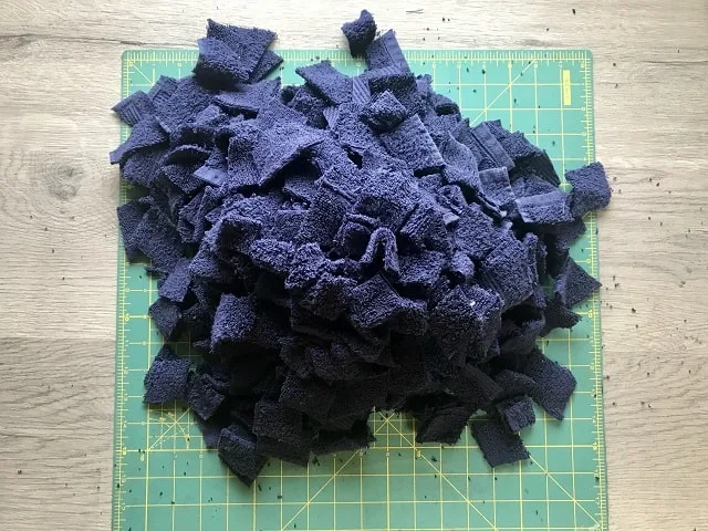 Pile of cut up cotton towel on cutting mat