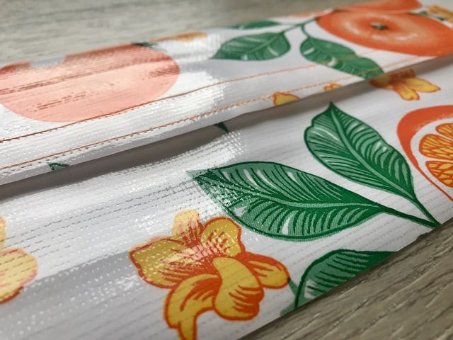 Top and bottom of oilcloth pieces held together with velcro