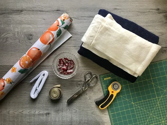 Supplies to make a DIY kneel pad - oilcloth, velcro, clips, towel, scissors, rotary cutter, cutting mat