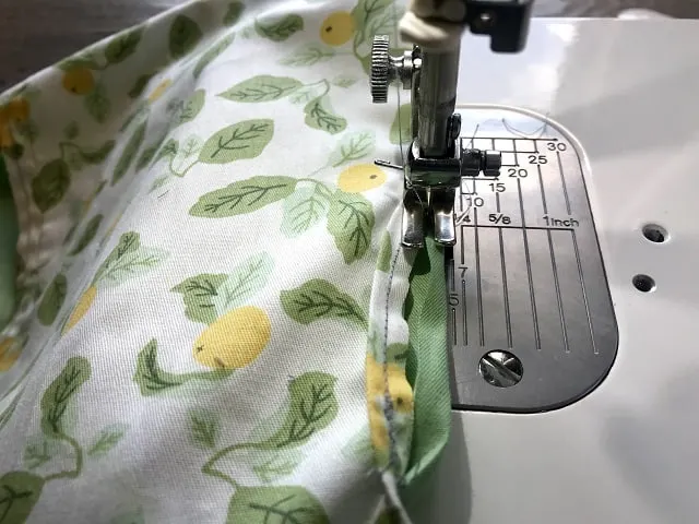Sewing machine sewing around opening for hanger