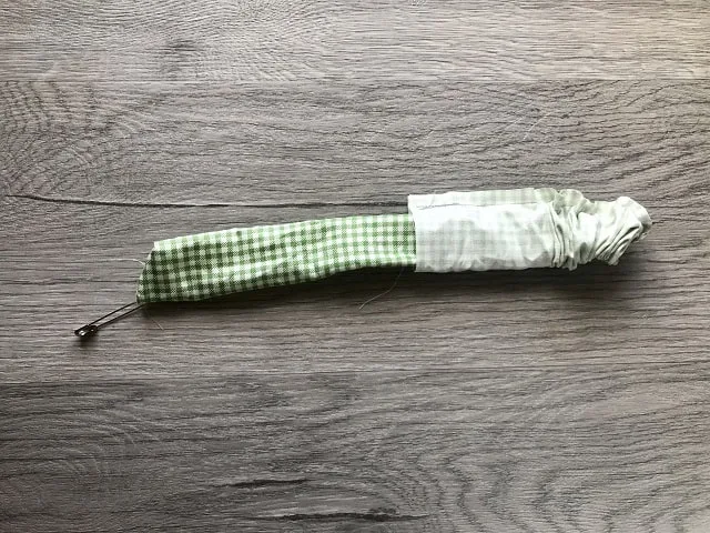 Tube of fabric being pushed through itself to turn right side out