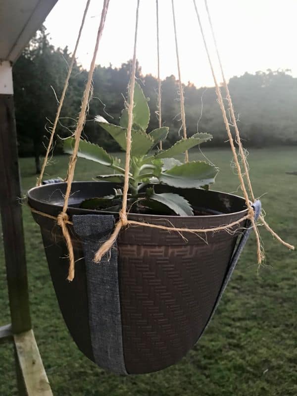 Close up of DIY Hanging Plant Holder made with twine and fabric hanging outside from porch