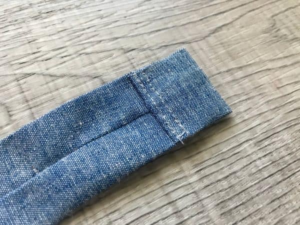 Fabric strip with end folded over and sewn with double stitch