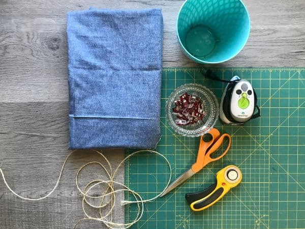 fabric, planter, sewing clips, iron, rotary cutter, cutting mat, scissors, twine