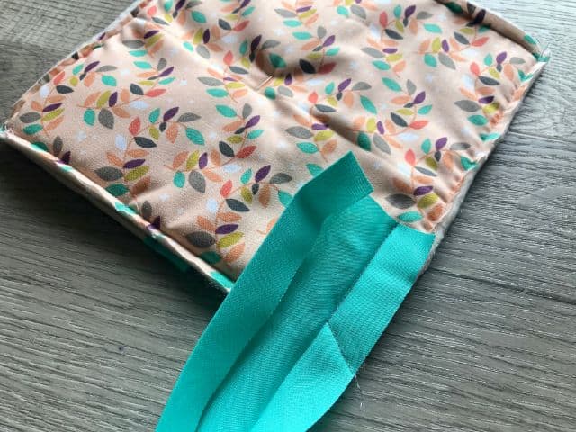 Hot pad with bias tape stitched to corner at an angle